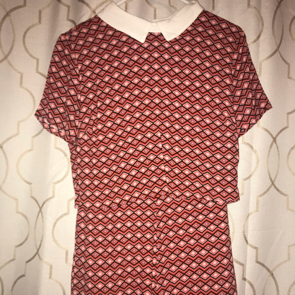 Pink and white and black collared romper.